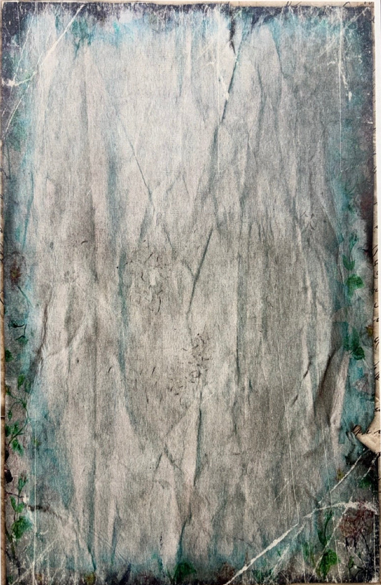 A square abstract art print or textured panel featuring a distressed, weathered design with a central gray and white crumpled-paper texture, surrounded by a teal and dark blue border, displayed on a dark wood background.