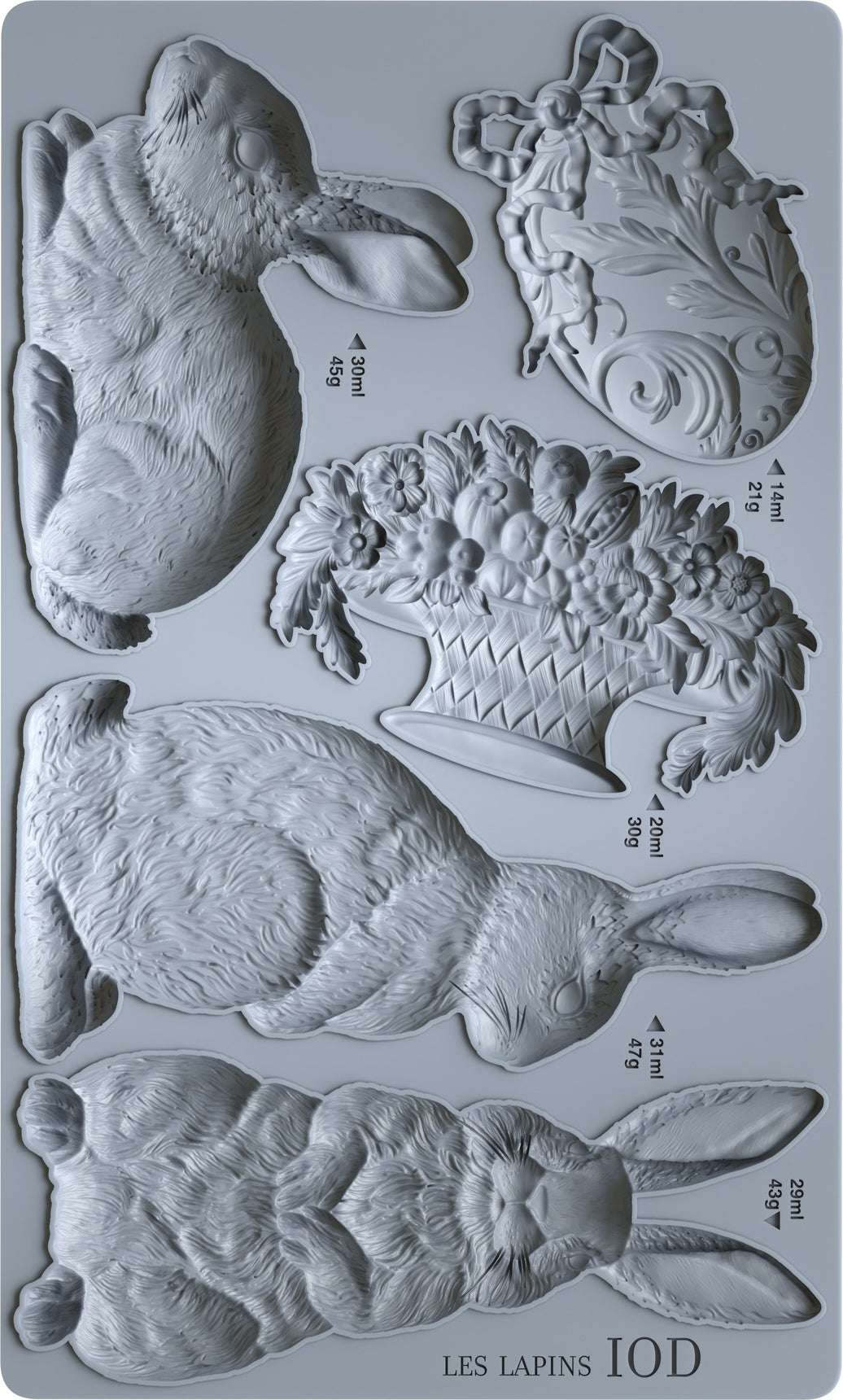 Set of chocolate molds shaped like rabbits and leaves on a gray background