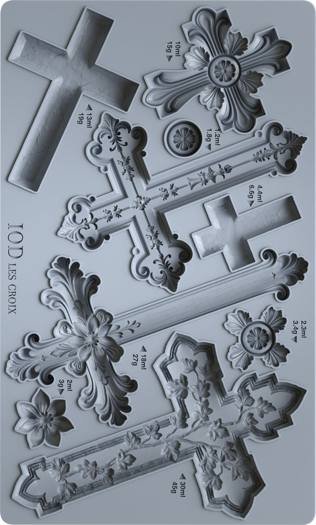 Metal cross-shaped cookie cutters with measurements on a gray background