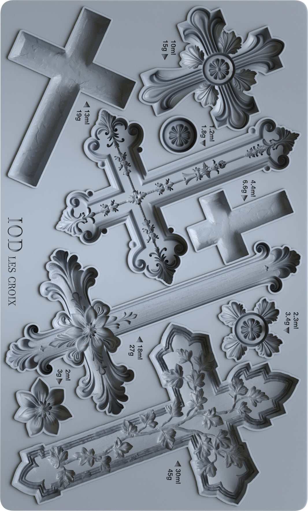 Metal cross-shaped cookie cutters with measurements on a gray background