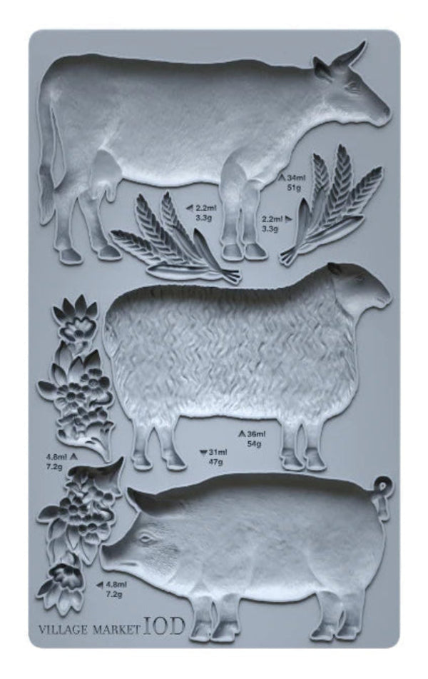 Silicone mold with cow, sheep, and goat shapes on a gray background