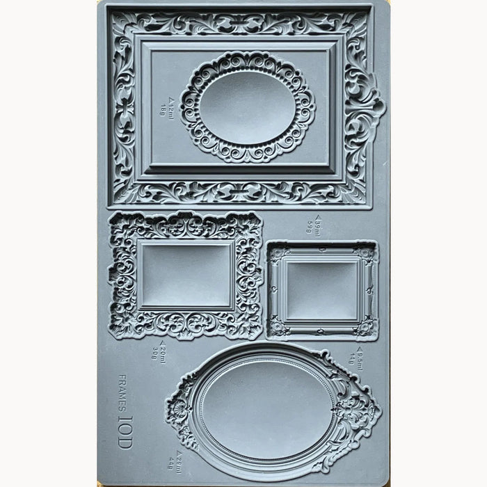 Decorative frame mold with intricate designs on a white background