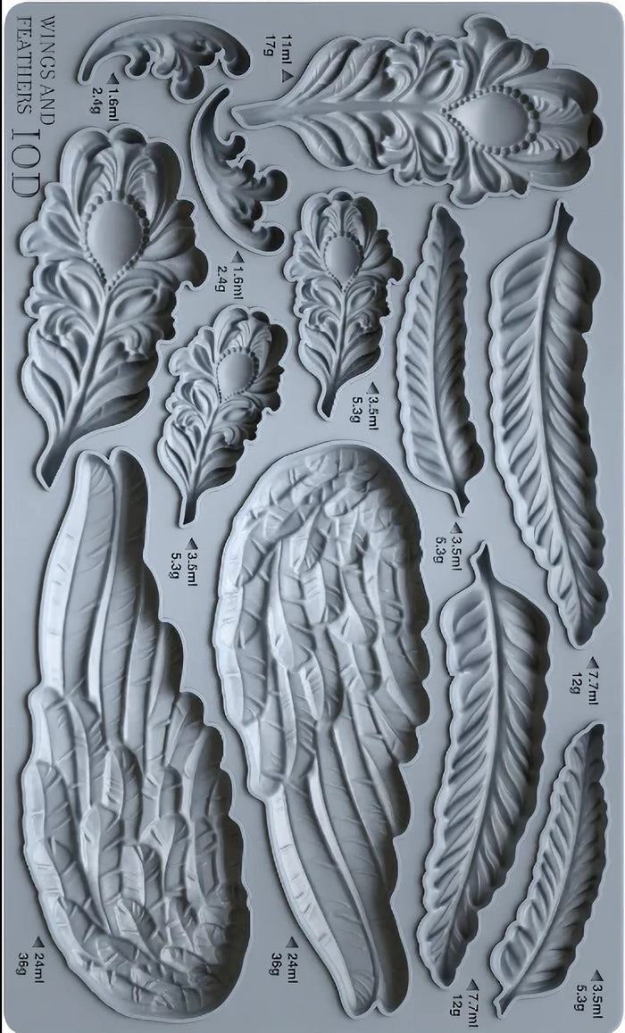 Mold with feather and wing designs on a gray background