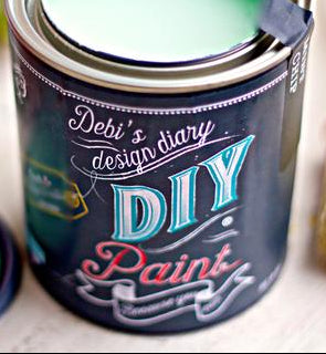 A can of debi's DIY paint in a mint chip color, with a brush next to it.