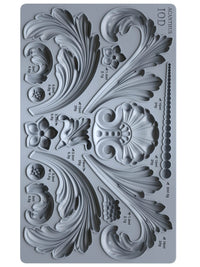 Decorative silicone mold with intricate designs and measurements on a gray background