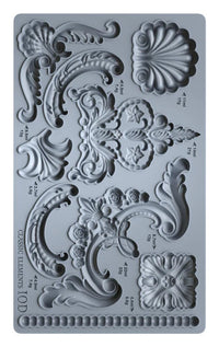 Decorative silicone mold with intricate designs and measurements on a gray background