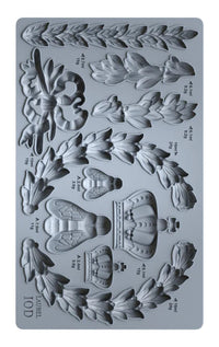 Silicone mold with floral and crown designs on a gray background