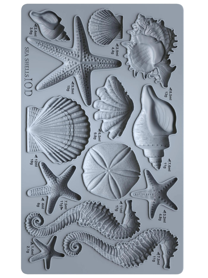Silicone mold with sea shell and starfish shapes on a gray background