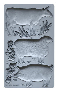 Silicone mold with cow, sheep, and goat shapes on a gray background