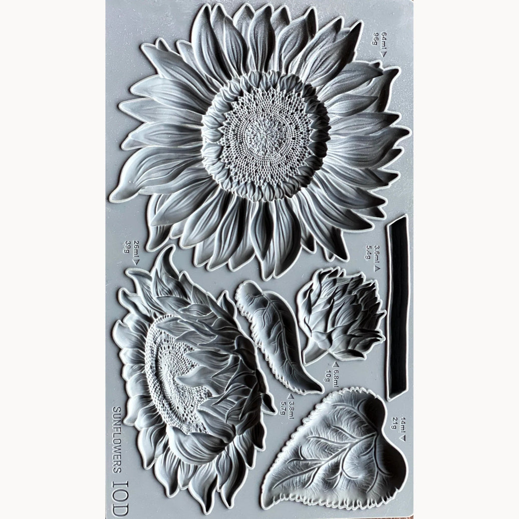 Clear stamp set with sunflower and leaf designs on a gray background