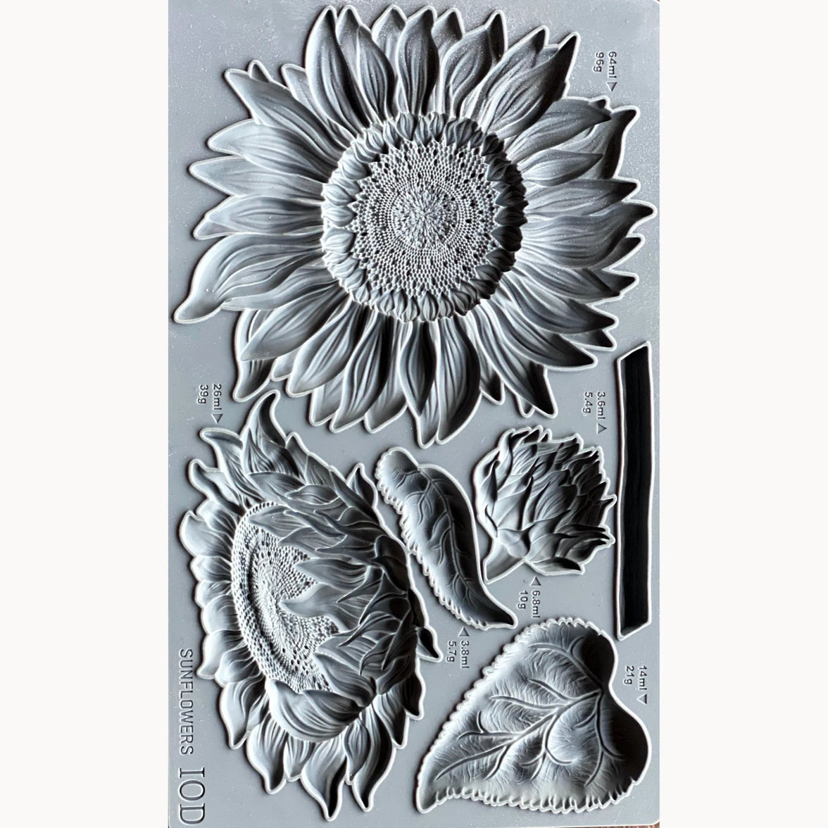 Clear stamp set with sunflower and leaf designs on a gray background