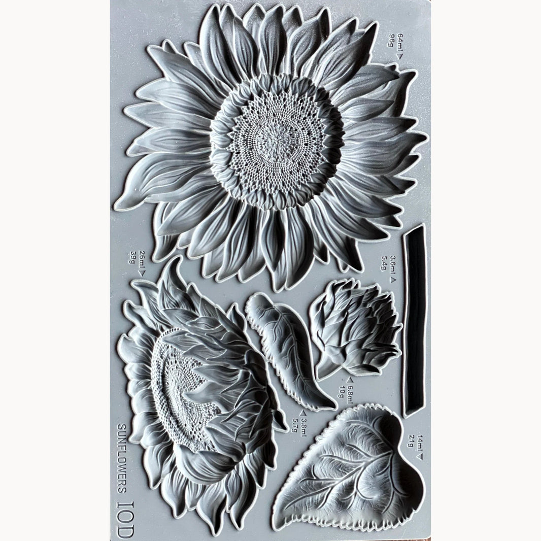 Clear stamp set with sunflower and leaf designs on a gray background